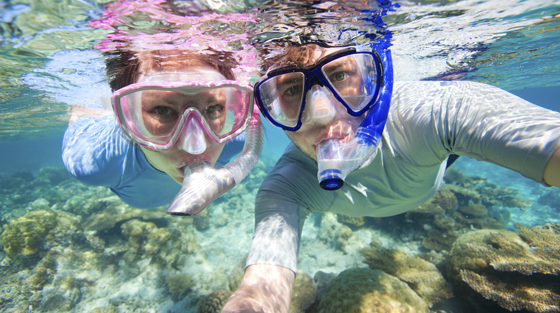 Two Travelers Snorkeling Underwater