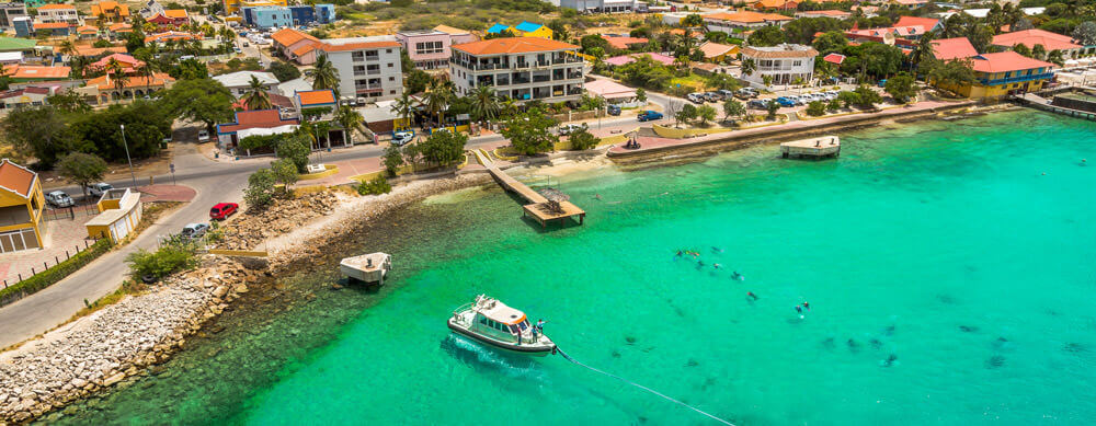Crystal clear water and fantastic food bring people to Bonaire. Let Passport Health help you stay healthy while you're there with travel advice and more.