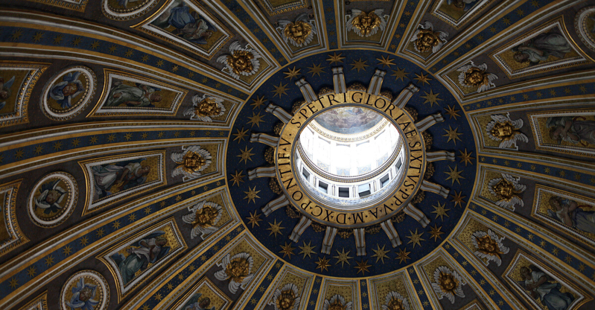 Clse shot, Oculus of the dome of the Sistine Chapel. Gold and blue paint and sculpture surround the oculus.
