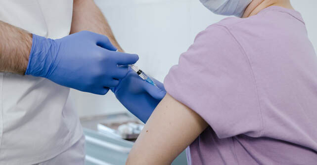 Healthcare provider administering a vaccine injection into a patient's arm