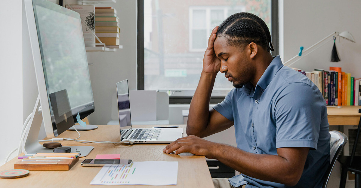 Man working at desk with computers in office